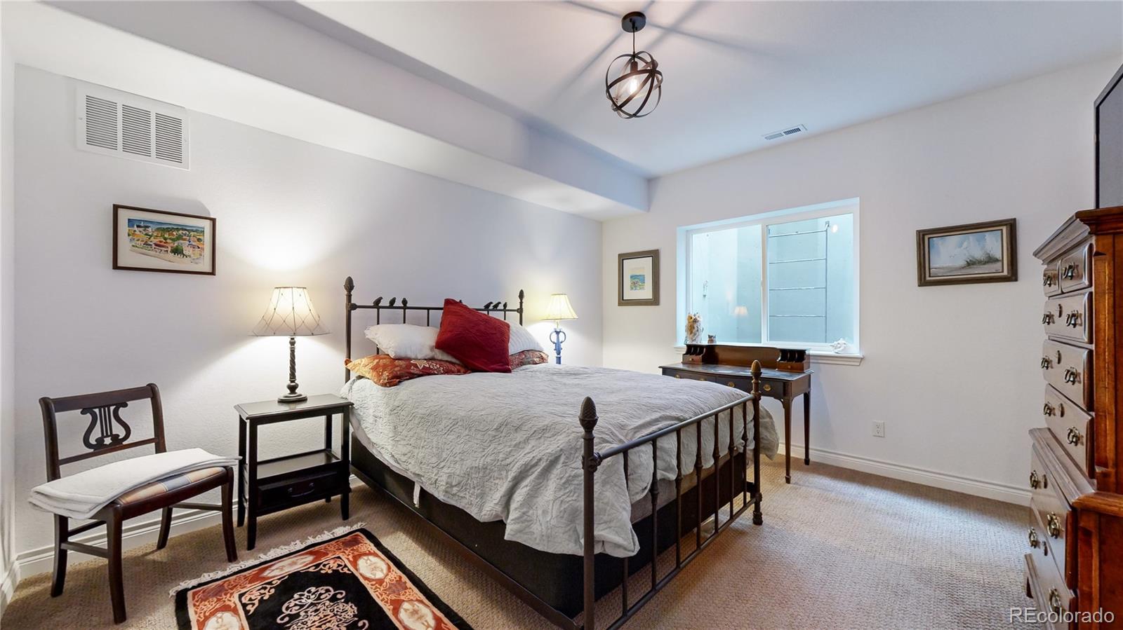 8400 Quaker Circle Arvada, CO 80007 - Photo 32 of 50 a bedroom with a bed a dresser and chair