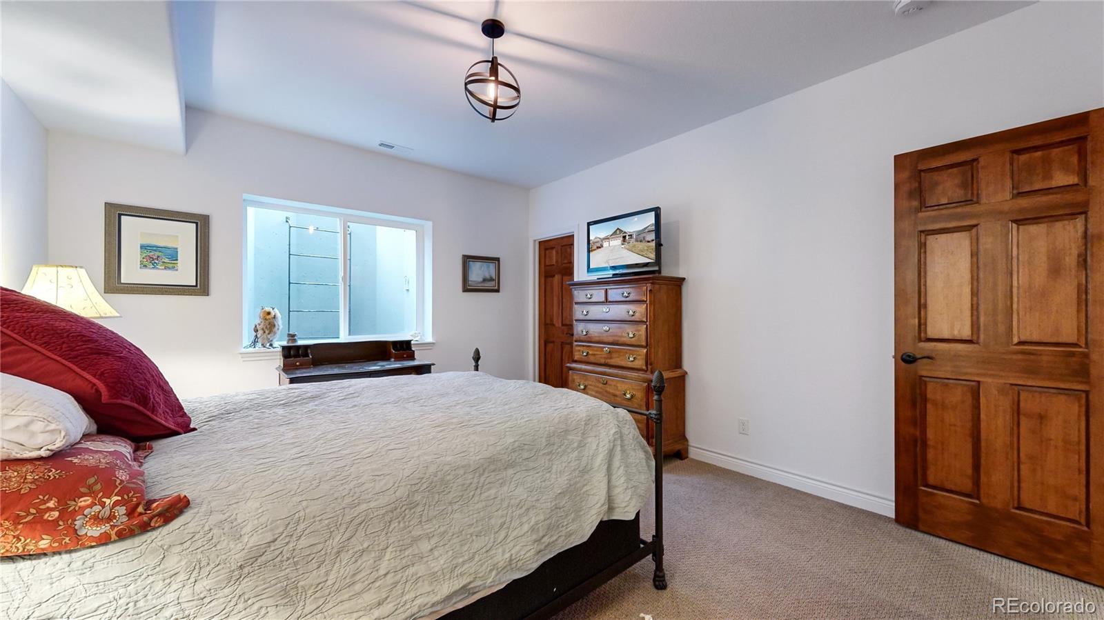 8400 Quaker Circle Arvada, CO 80007 - Photo 33 of 50 a bedroom with a bed and a dresser