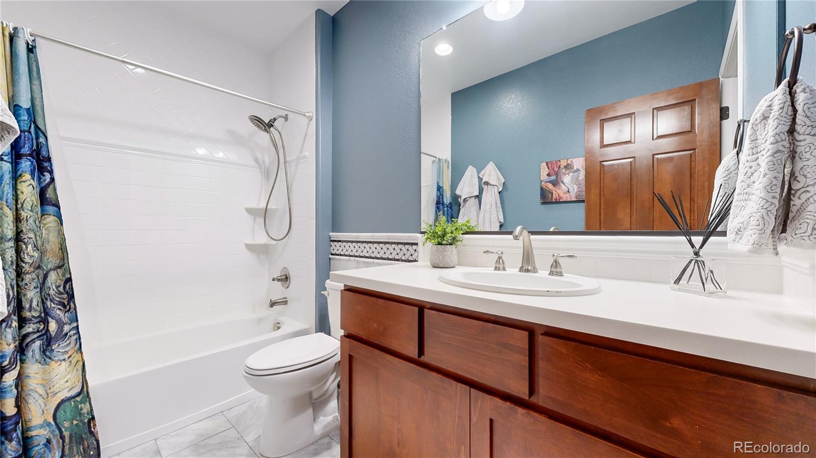 8400 Quaker Circle Arvada, CO 80007 - Photo 34 of 50 a bathroom with a sink a toilet and shower