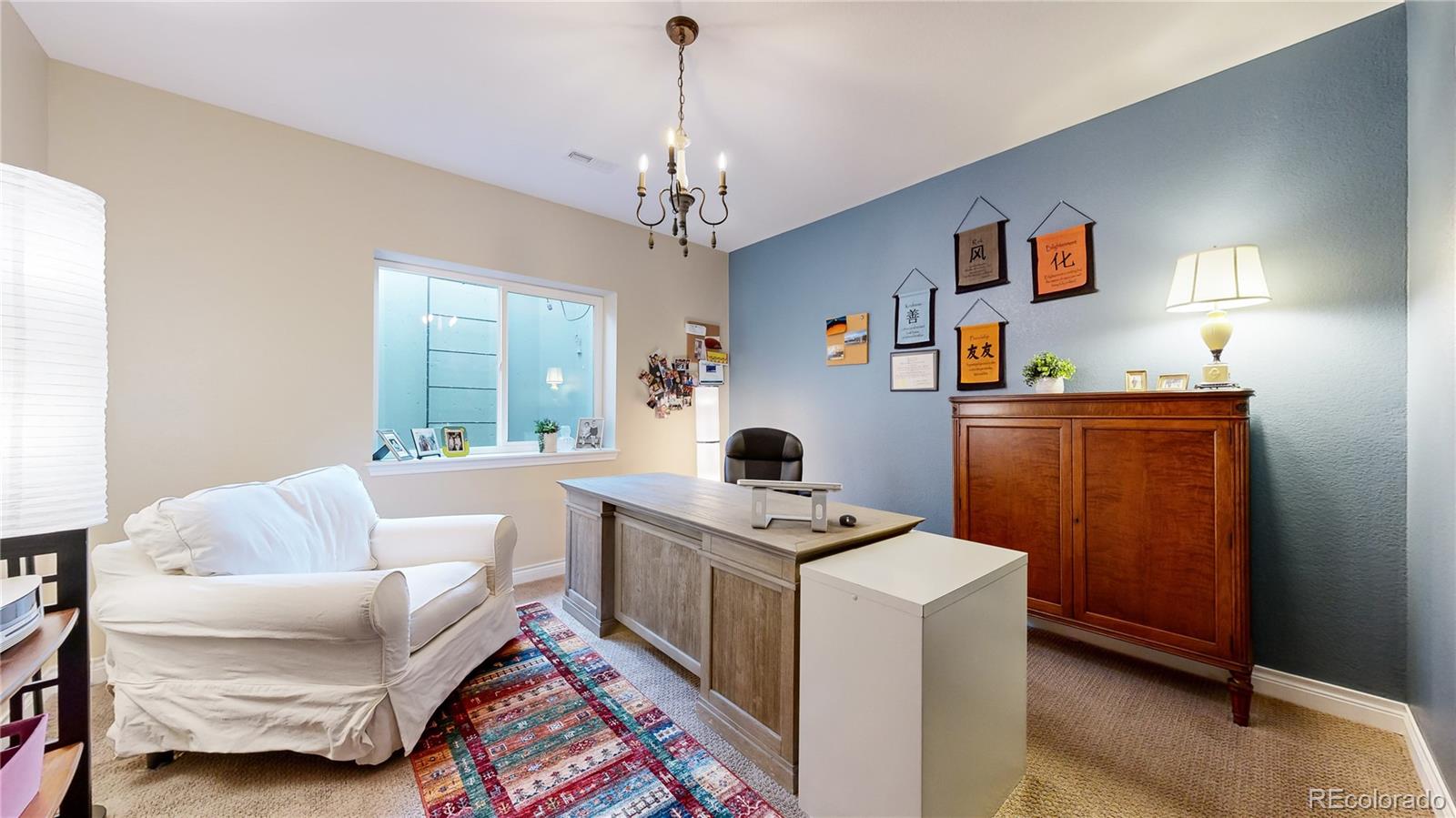 8400 Quaker Circle Arvada, CO 80007 - Photo 36 of 50 a living room with furniture and a chandelier