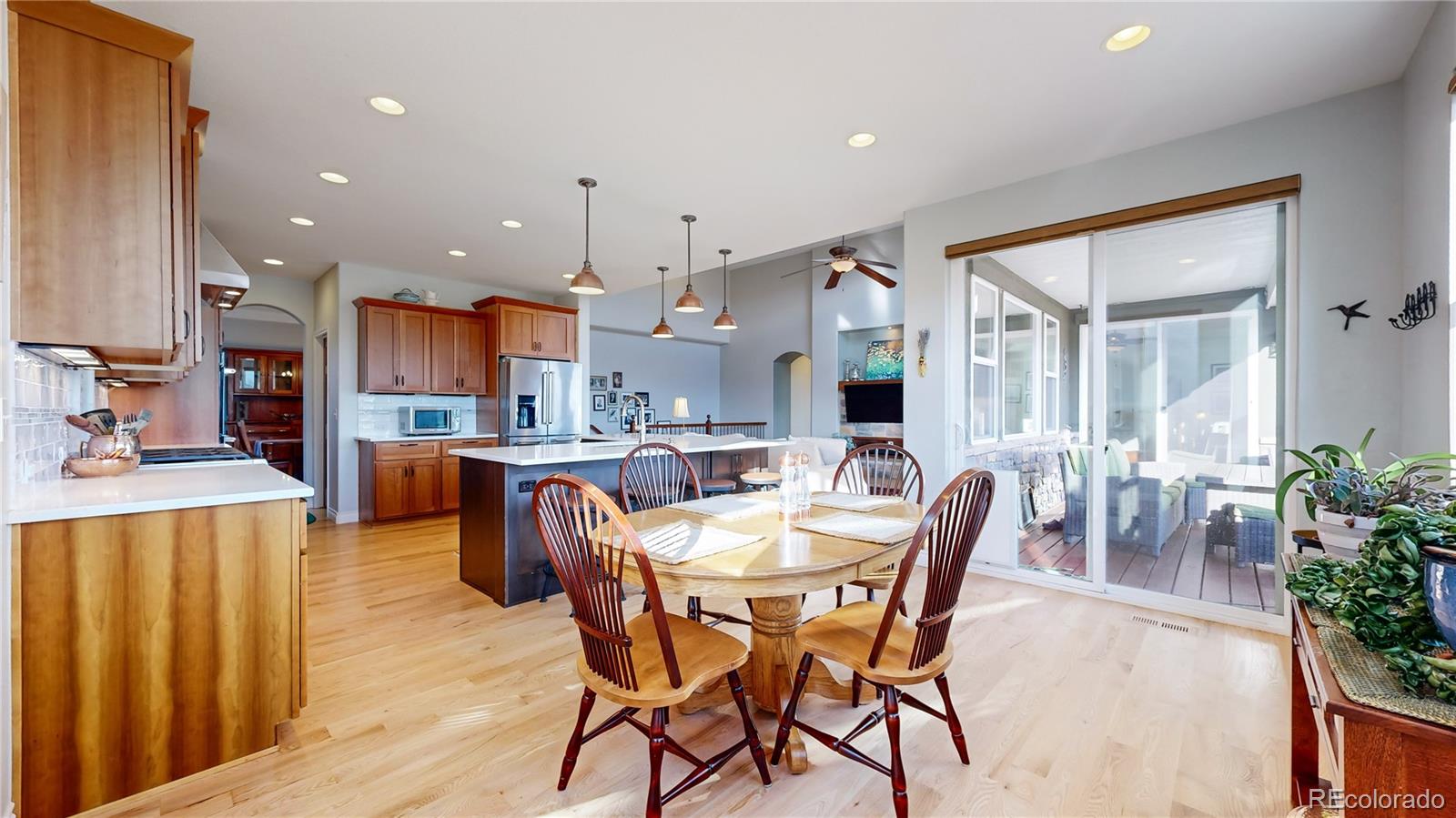8400 Quaker Circle Arvada, CO 80007 - Photo 5 of 50 a view of a dining room with furniture and wooden floor
