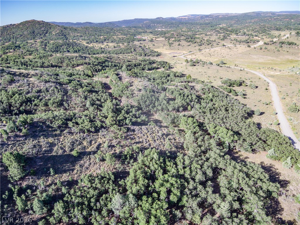 495 West Lutherwood Road Alton, UT 84710 - Photo 25 of 35 A winding path traverses this verdant, hilly lot, offering sweeping views of distant mountains.