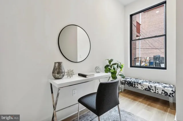 a living room with furniture a mirror and a table