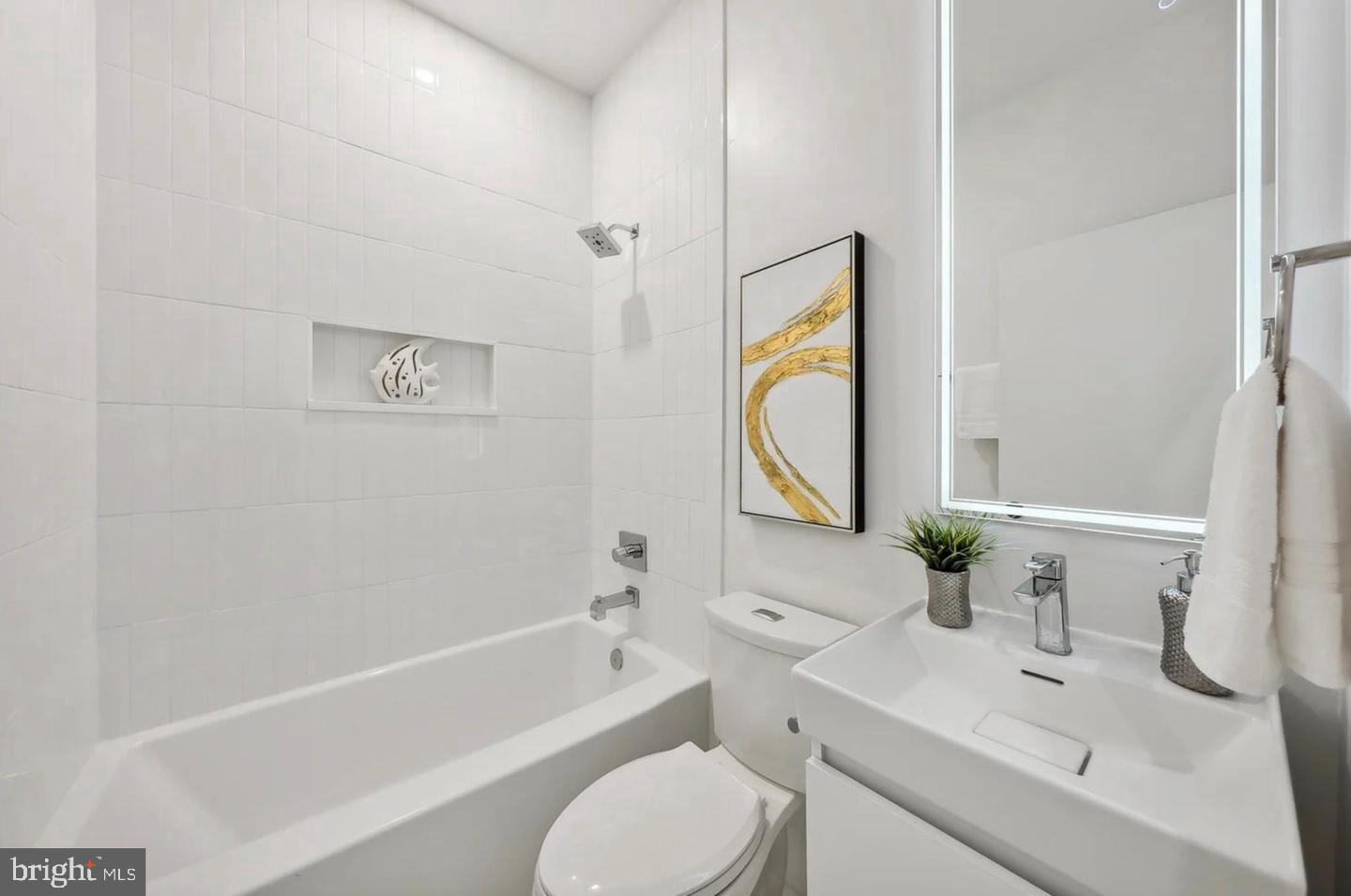 2015 13th Street Northwest, Unit 2 Washington, DC 20009 - Photo 20 of 42 a bathroom with a granite countertop sink toilet a mirror and bathtub