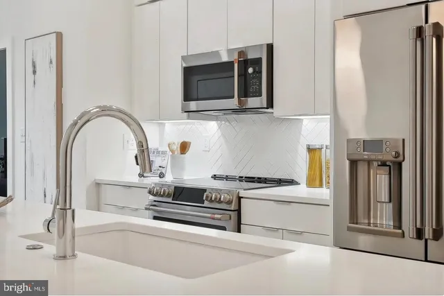 a stove top oven sitting inside of a kitchen