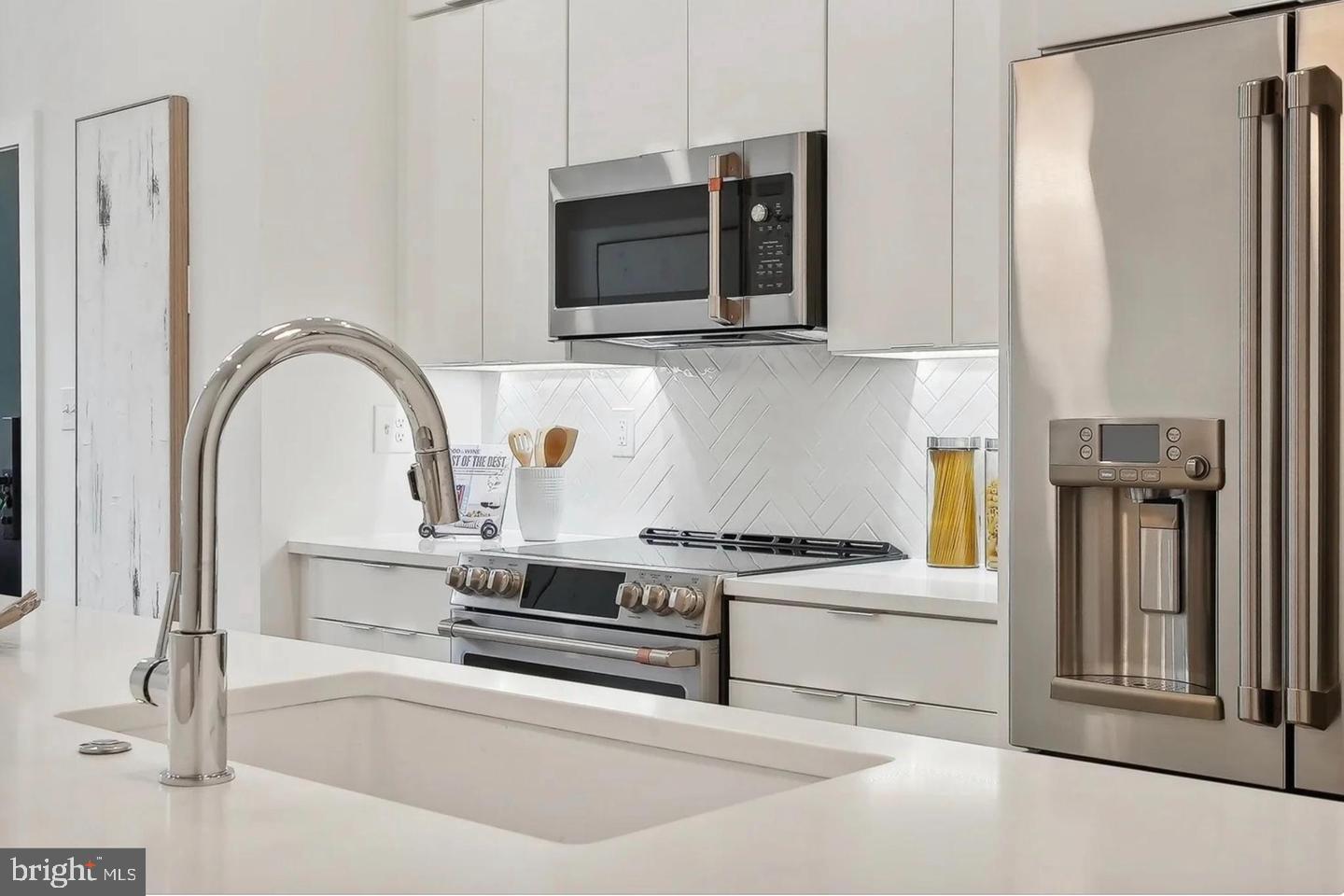 2015 13th Street Northwest, Unit 2 Washington, DC 20009 - Photo 10 of 42 a kitchen with stainless steel appliances granite countertop a stove and a microwave