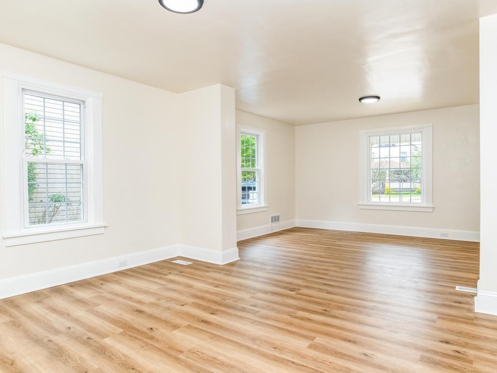 1660 Mercer Road Ellwood City, PA 16117 - Photo 12 of 41 an empty room with wooden floor and windows