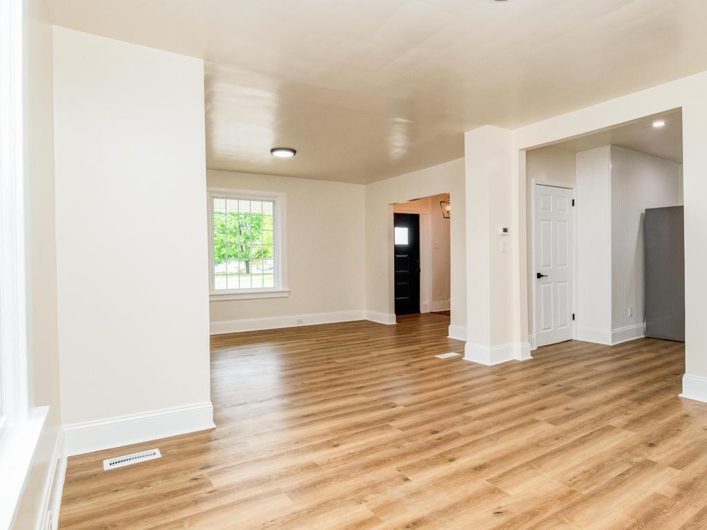 1660 Mercer Road Ellwood City, PA 16117 - Photo 13 of 41 a view of an empty room with wooden floor and a window