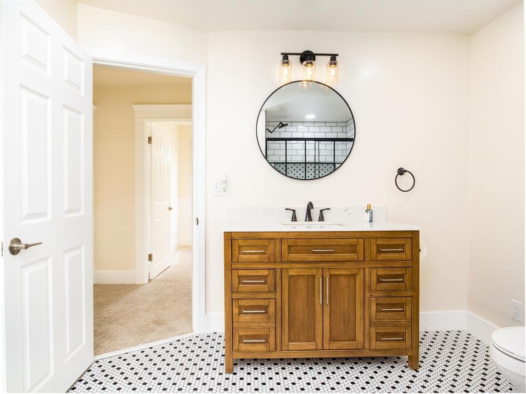 1660 Mercer Road Ellwood City, PA 16117 - Photo 17 of 41 a bathroom with a sink a vanity and a mirror