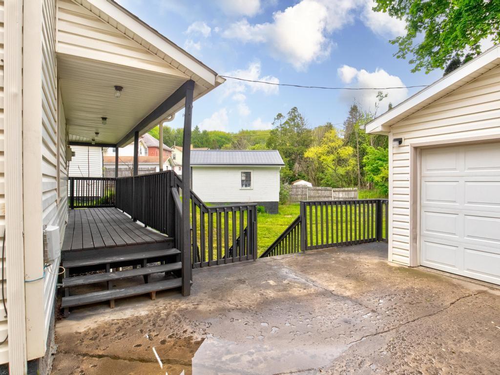 1660 Mercer Road Ellwood City, PA 16117 - Photo 18 of 41 a view of a porch with a small yard