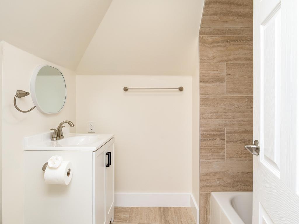 1660 Mercer Road Ellwood City, PA 16117 - Photo 29 of 41 a bathroom with a sink a mirror and shower