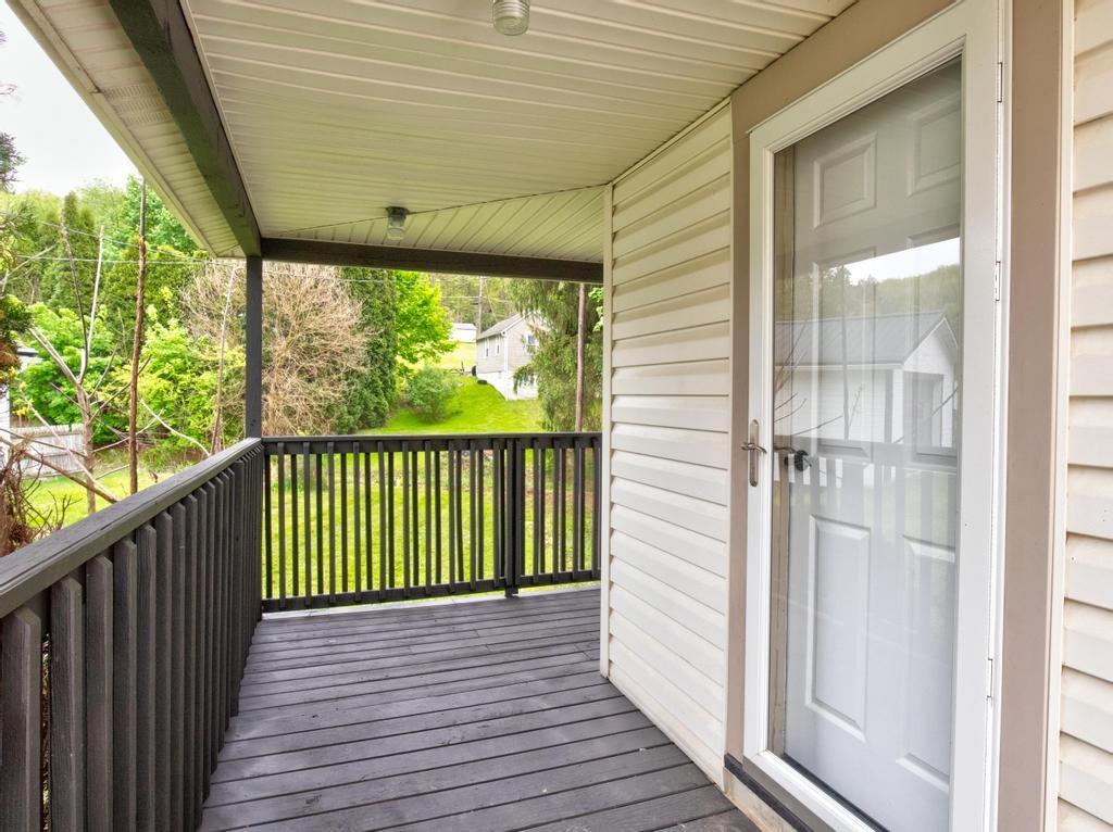 1660 Mercer Road Ellwood City, PA 16117 - Photo 6 of 41 a view of a porch with wooden floor and outdoor space