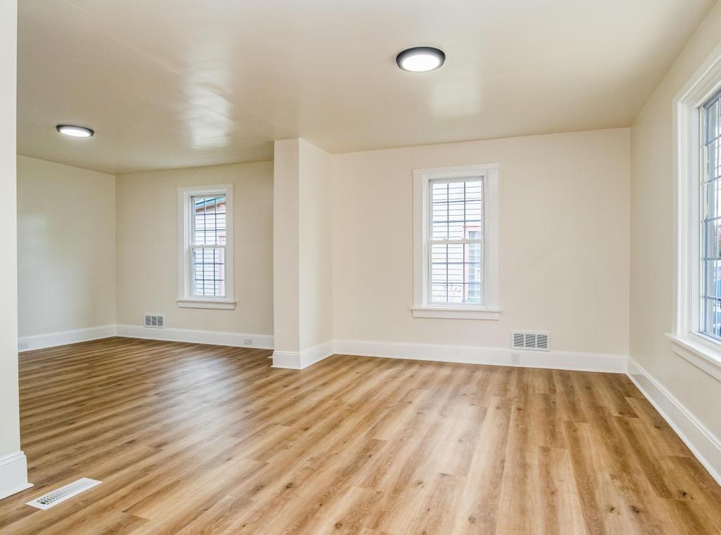 1660 Mercer Road Ellwood City, PA 16117 - Photo 8 of 41 an empty room with wooden floor and windows