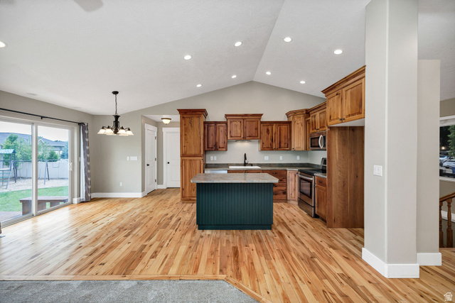 2912 South 1080th Street West Logan, UT 84321 - Photo 28 of 43 Open-concept kitchen and dining area featuring wood-finish flooring, a vaulted ceiling, and recessed lighting