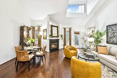 a living room with furniture fireplace and dining table