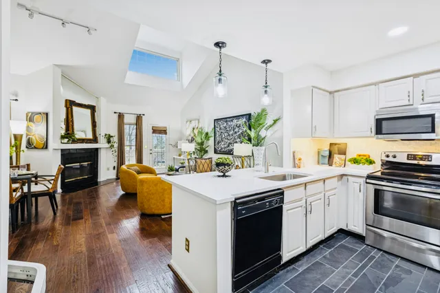 a kitchen with a sink and stove top oven