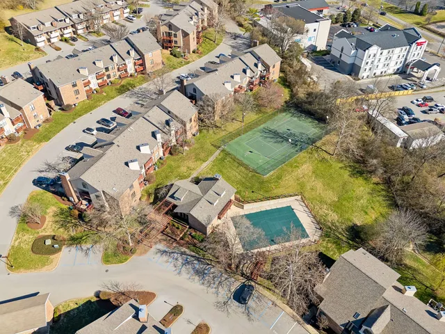 a bedroom with a bed and chandelier