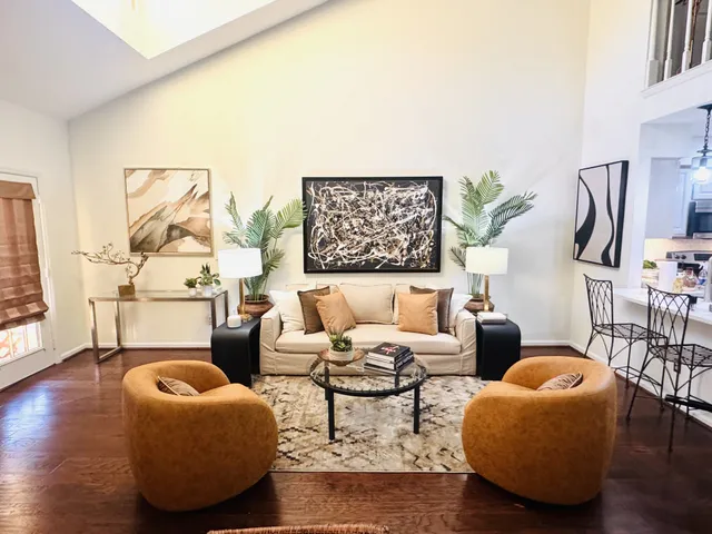 a living room with furniture and a floor to ceiling window
