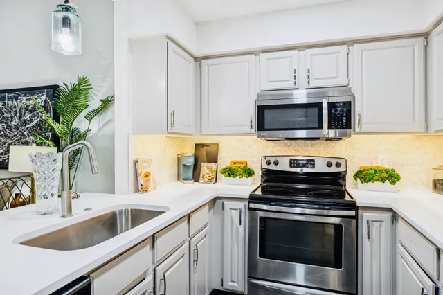 a kitchen with a sink stove and microwave