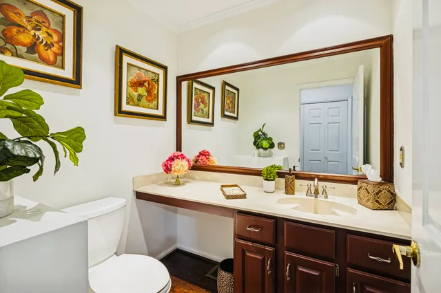 a bathroom with a sink vanity mirror and toilet