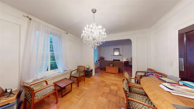 a living room with furniture and a chandelier
