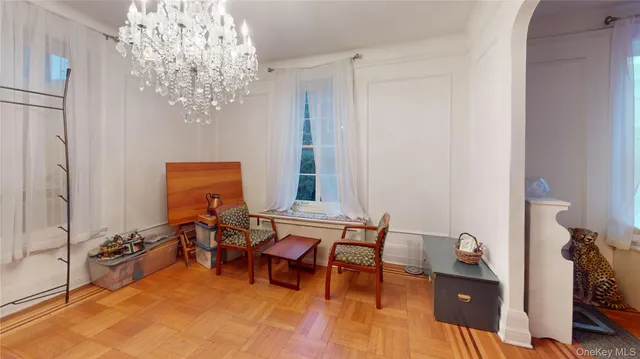 a view of a room with furniture and chandelier
