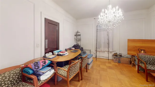 a dining room with furniture and chandelier