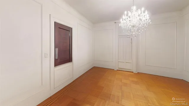 a view of an empty room with a chandelier