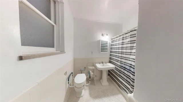 a white toilet sitting next to a bathroom sink