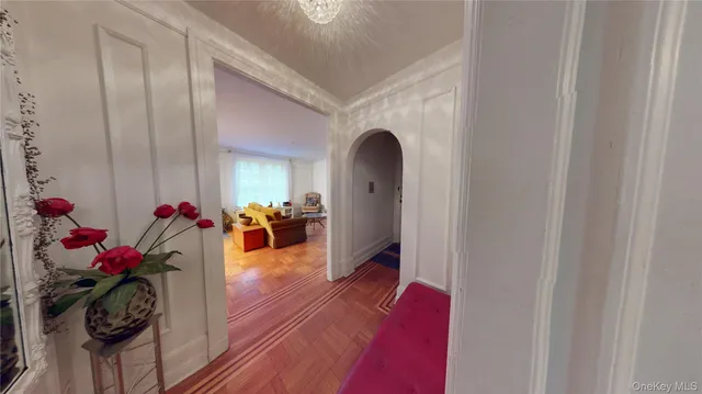 a living room with furniture and a chandelier