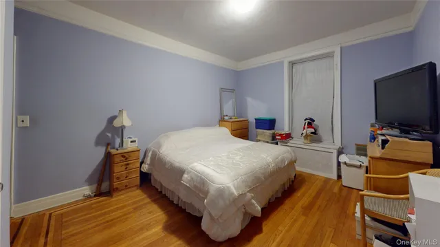 a bed room with a bed and a television