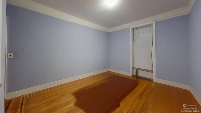 a view of a room with wooden floor