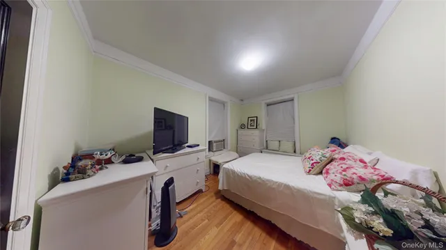 a bedroom with a bed and a tv