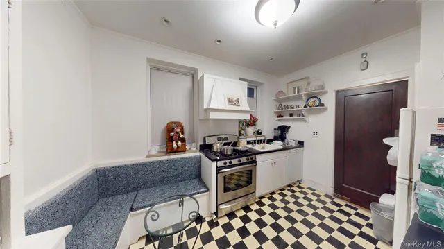 a kitchen with stainless steel appliances granite countertop a stove and a refrigerator