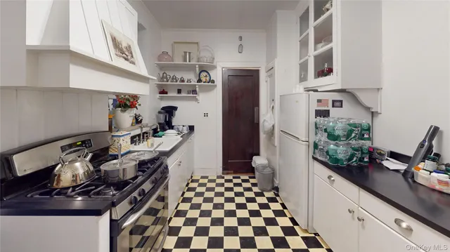 a kitchen with stainless steel appliances a stove and a refrigerator