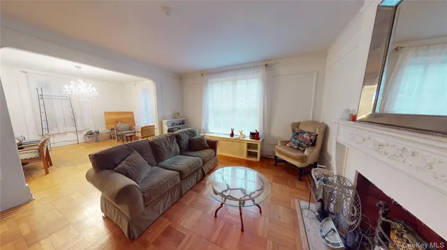 a living room with furniture a fireplace and a large window