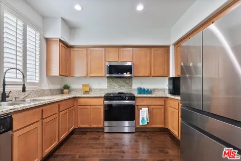 a kitchen with a sink stove and refrigerator