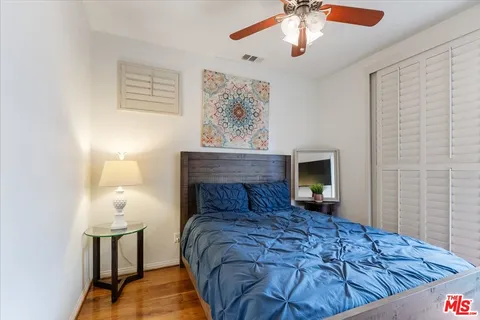 a bedroom with a bed tv and a chandelier