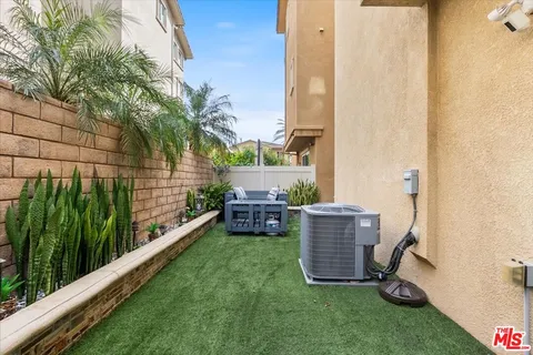 a view of a chairs and table in a backyard