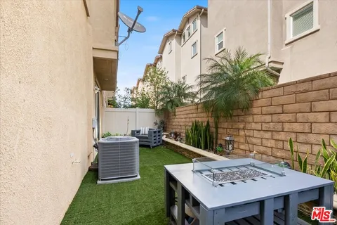 a row of palm trees in front of house