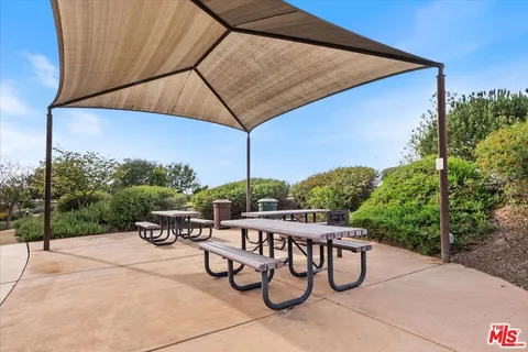 a view of yard with swimming pool and furniture