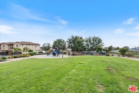 a view of a park with swings and slides