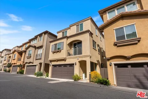 a view of multiple houses with street