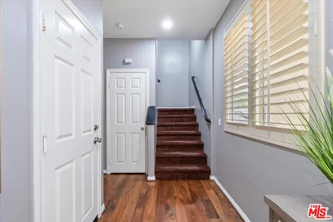 a view of entryway with wooden floor and stairs