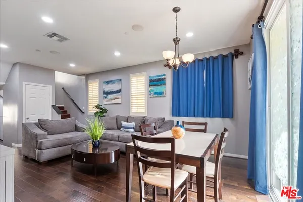 a view of a dining room with furniture window and wooden floor