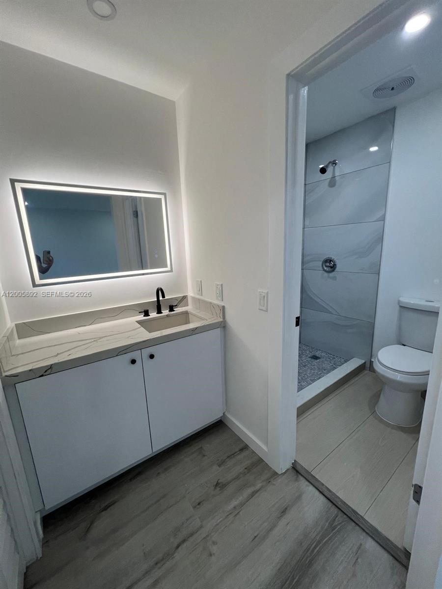 3632 Southwest 112th Avenue, Unit 63 Miami, FL 33165 - Photo 12 of 14 a bathroom with a sink a toilet and shower