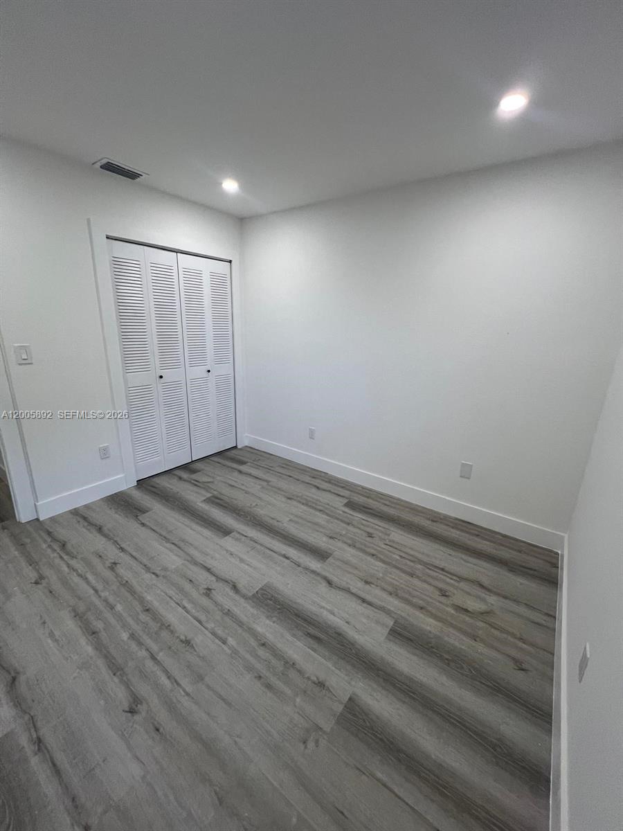 3632 Southwest 112th Avenue, Unit 63 Miami, FL 33165 - Photo 13 of 14 an empty room with wooden floor