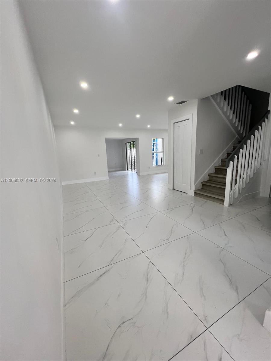 3632 Southwest 112th Avenue, Unit 63 Miami, FL 33165 - Photo 6 of 14 a view of an empty room with stairs