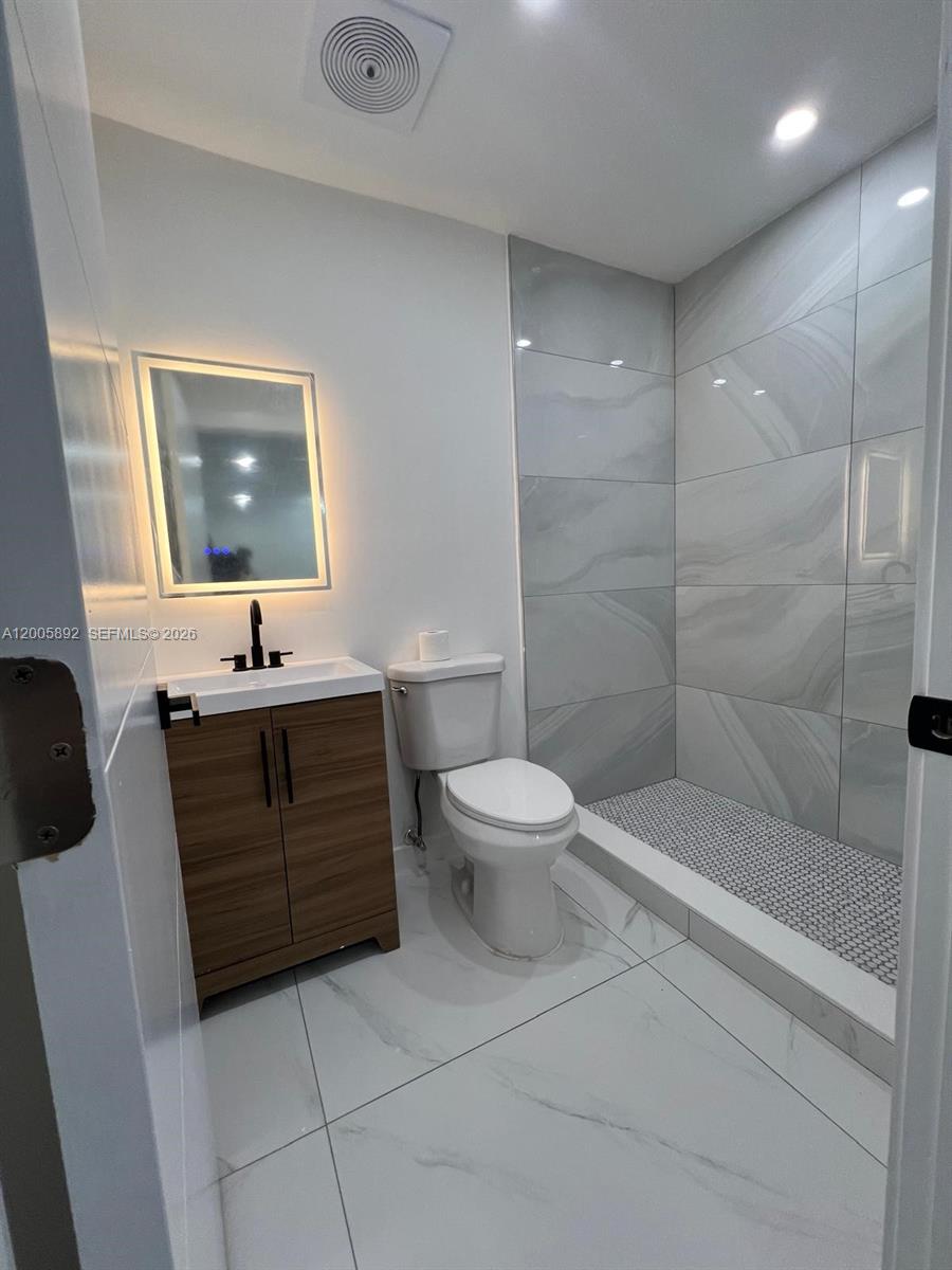 3632 Southwest 112th Avenue, Unit 63 Miami, FL 33165 - Photo 9 of 14 a bathroom with a sink a toilet and shower