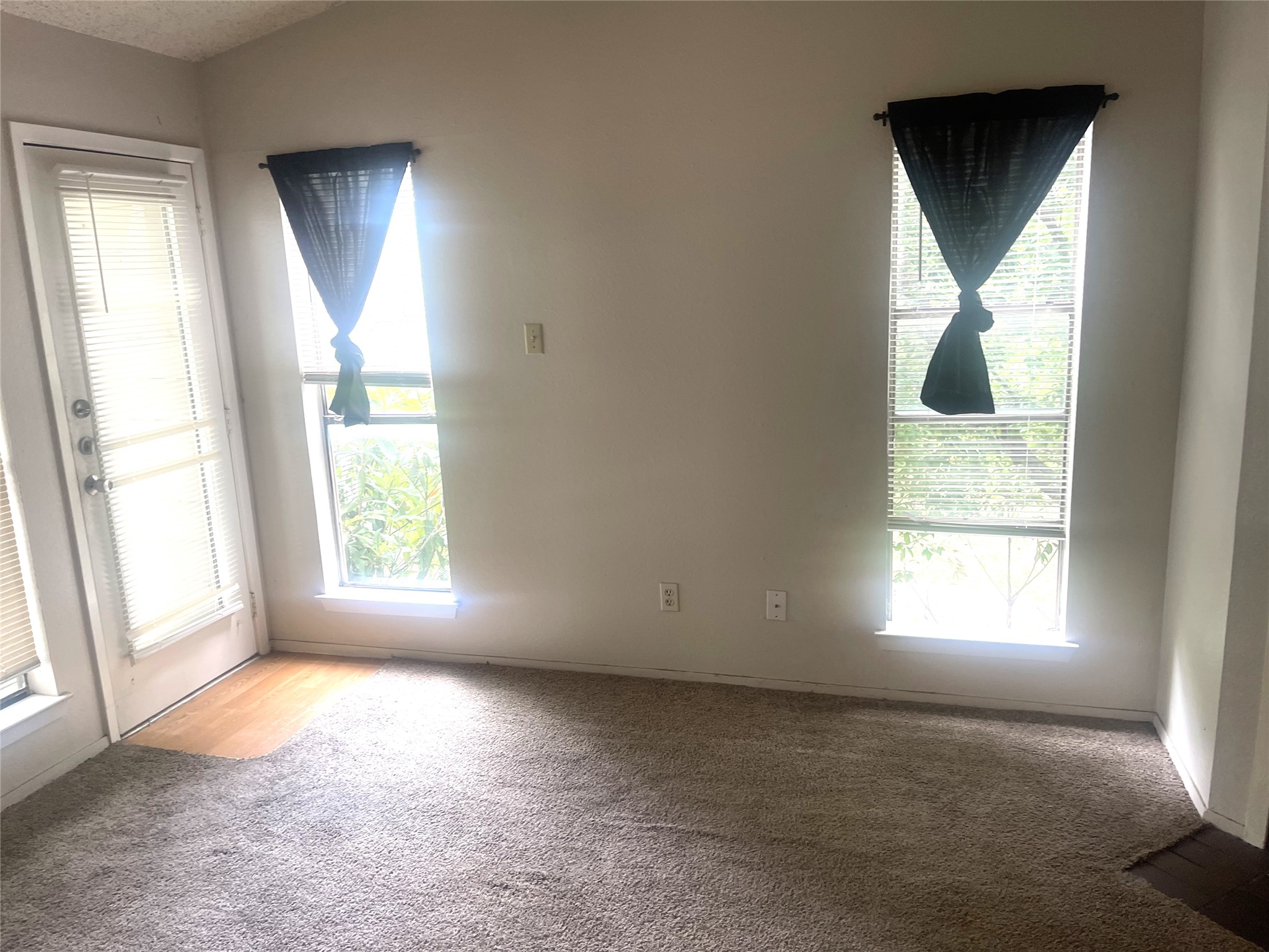 2005 West Loop, Unit D1 Austin, TX 78758 - Photo 14 of 31 an empty room with windows and mirror